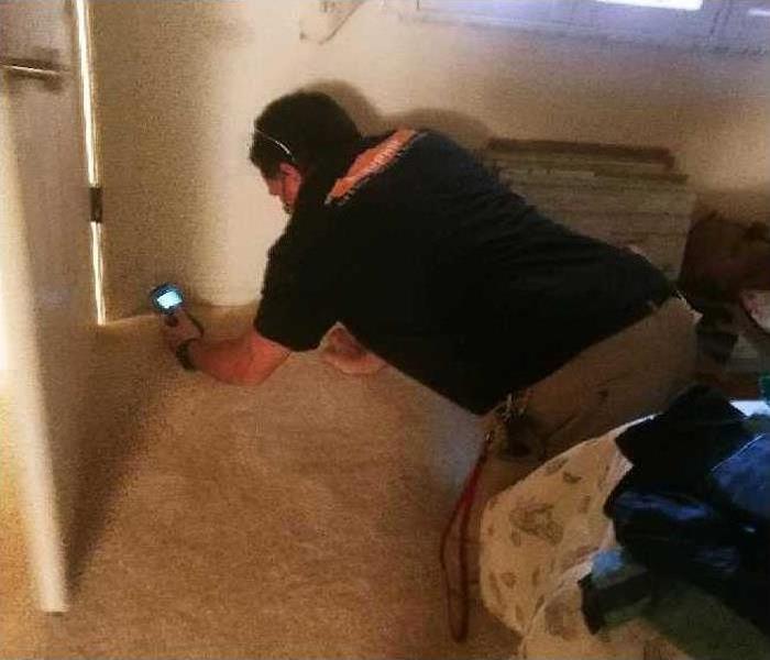 SERVPRO technician testing the moisture content of a wall