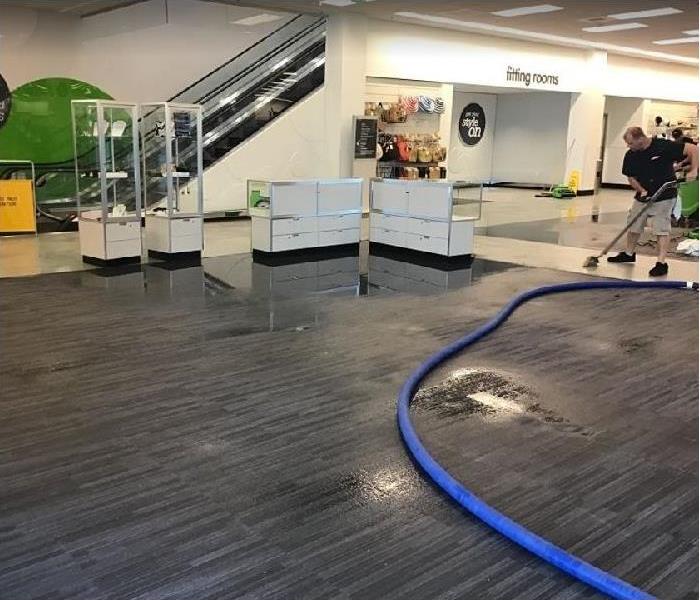 SERVPRO tech removing water from water damaged retail business