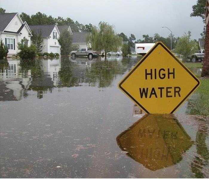 flood sign barricade on water filled roadway
