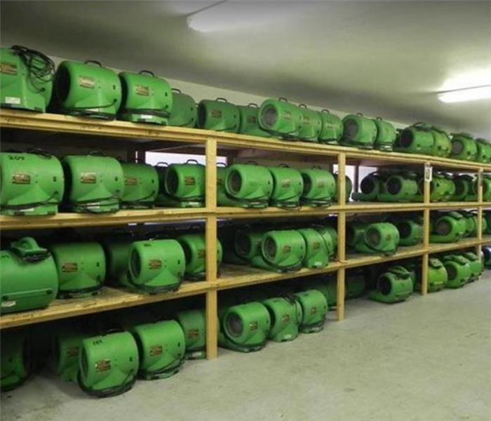 shelves of SERVPRO equipment in a warehouse